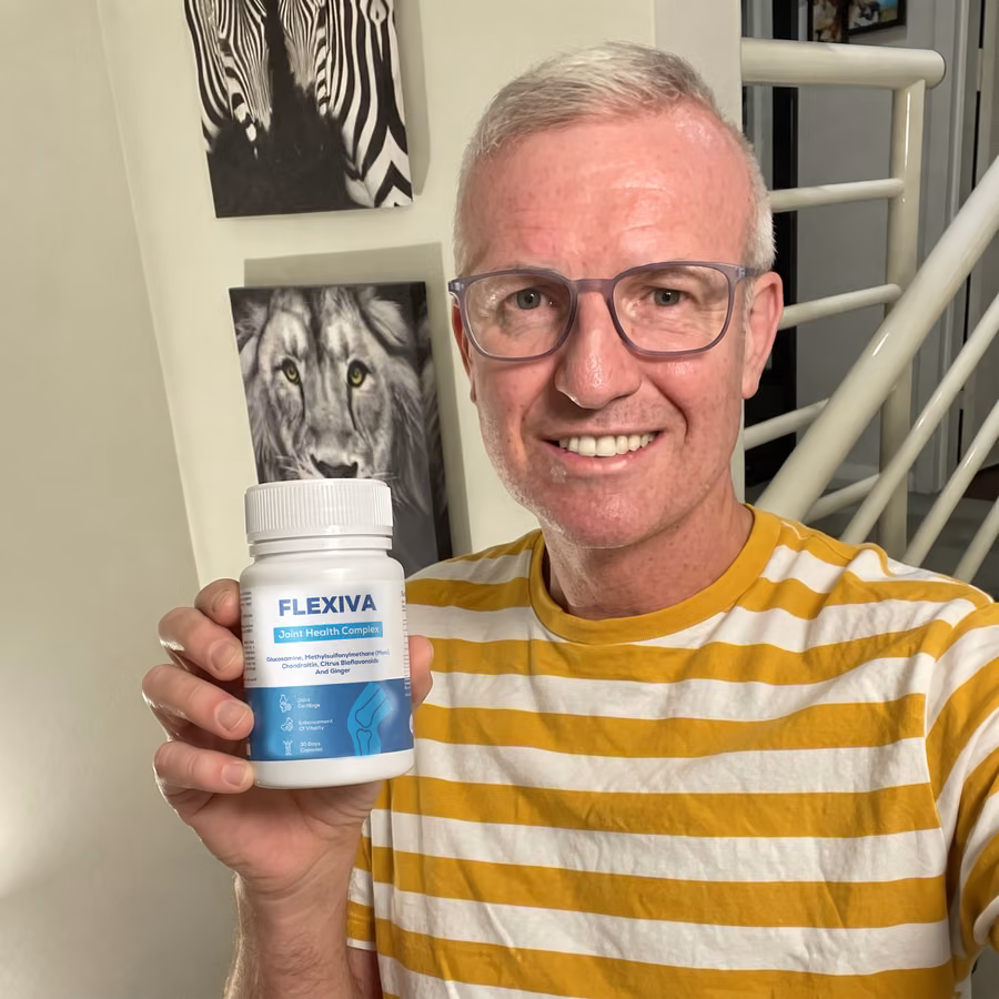 Smiling man in a yellow striped T-shirt holding up a jar of Flexiva